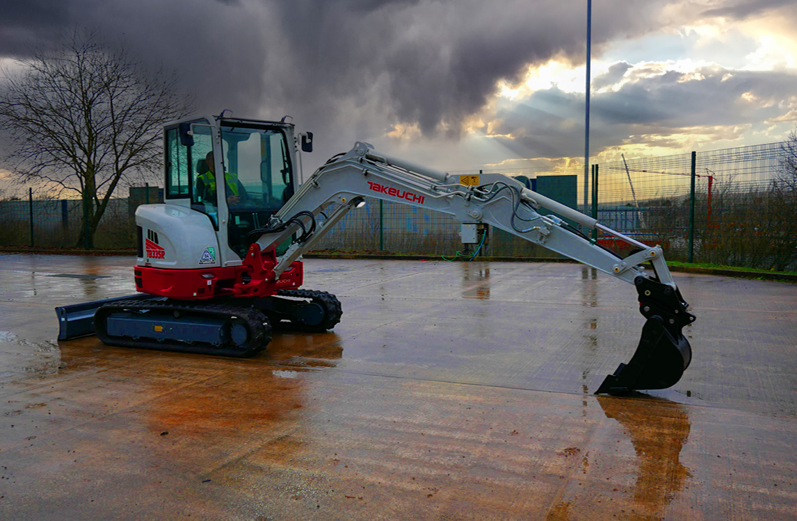 TB335R Compact Excavator with boom arm out and bucket placed to floor parked up