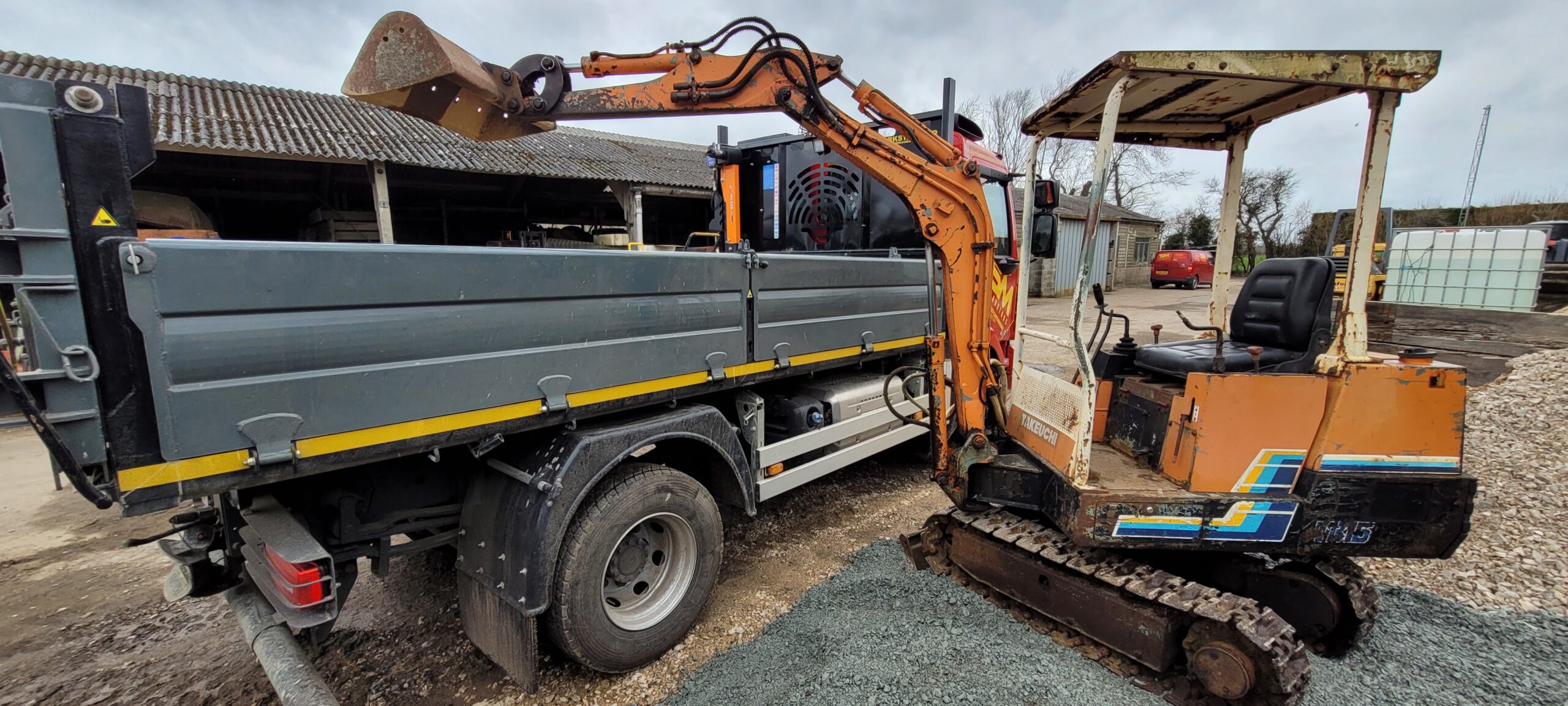 takeuchi digger with boom in pouring position