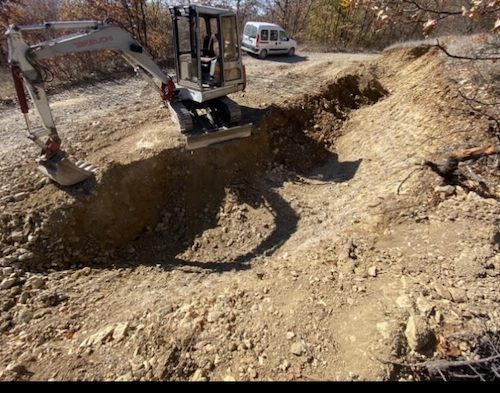 old tb035 takeuchi digger next to hole with boom down