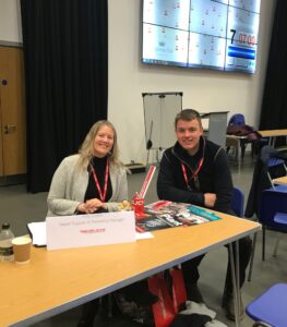 two people sat down at career day for takeuchi 