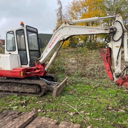 Takeuchi TB145 Digger about to dig on grass in the UK