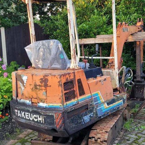 Old takeuchi excavator digger painted orange with logo on the back owned by Steve shevill