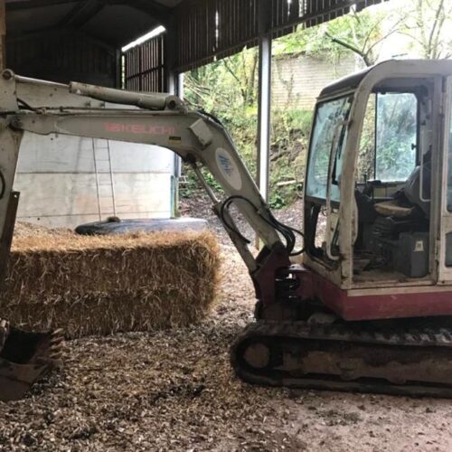 TB125 Takeuchi excavator parked in shelter