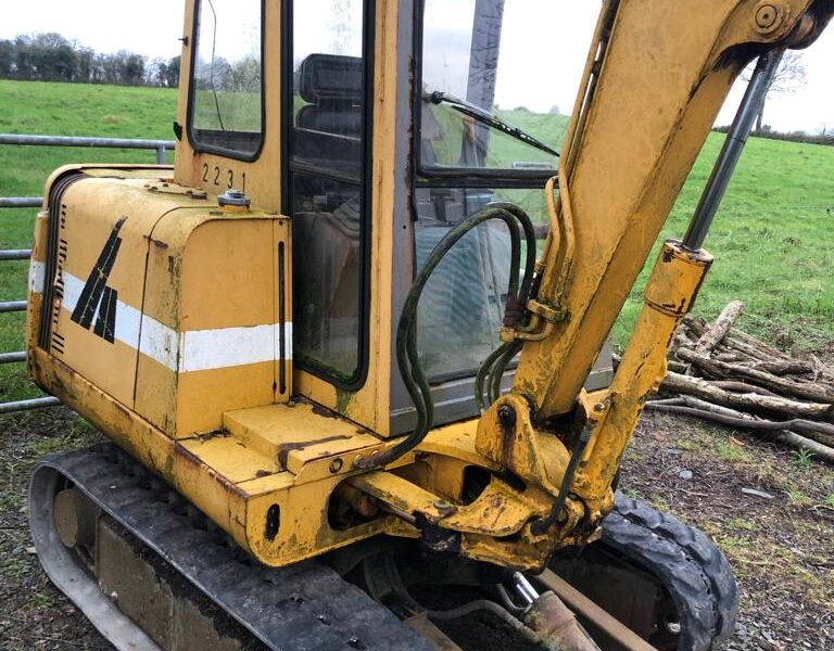 yellow takeuchi digger parked up