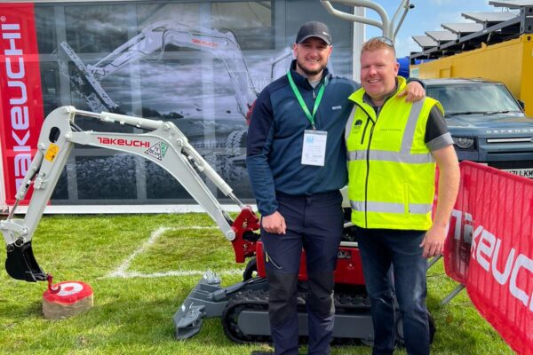 operator stood with dave vickers in front of takeuchi digger