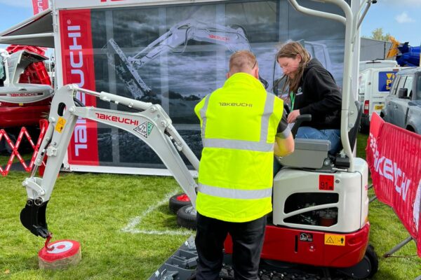 operator getting instructions on how to use digger