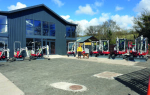 mann hire depot with takeuchi excavators lined up in front