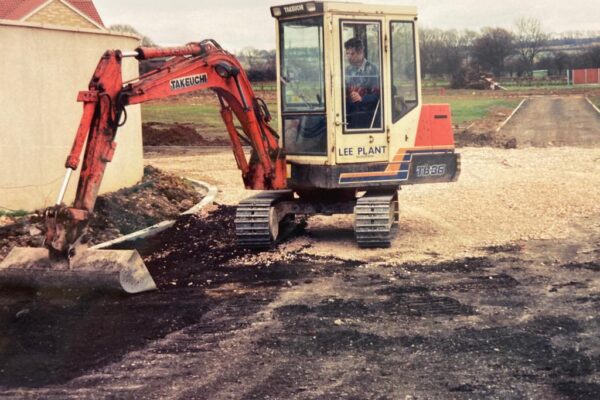 orange takeuchi digger operating