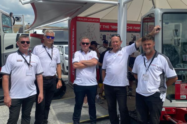 takeuchi sales team at hillhaed stoofd in front of digger