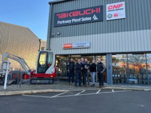 parkway plant team stood outside depot with takeuchi award 