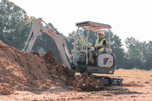 canopy takeuchi electric digger outside about to lift