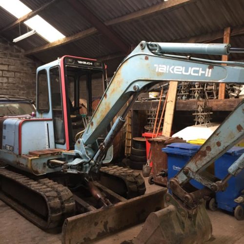 TB045 Takeuchi working digger in a workshop painted blue with white logo