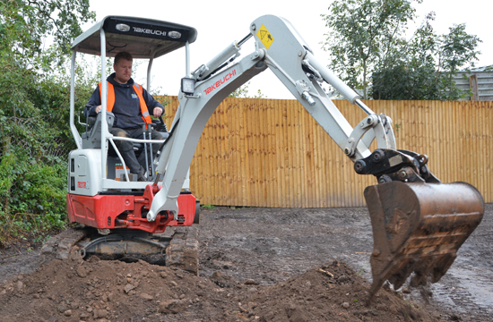 takeuchi tb217r digger with boom out in the UK. It is a 1 tonne machine