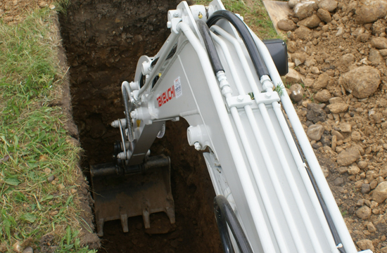 takeuchi tb219 digger view from cabin of the boom digging a hole on a construction site