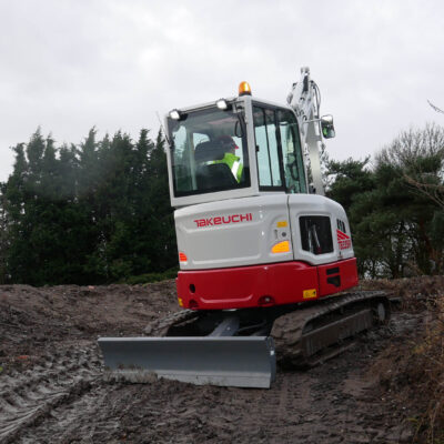 tb335r takeuchi compact excavator driving up hill