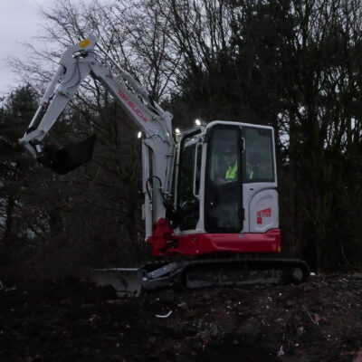 takeuchi tb335r compact excavator in dark with led LIGHTS ON