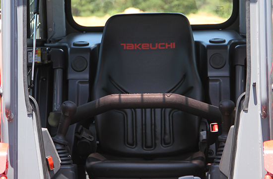 black operator seat inside a tracked loader