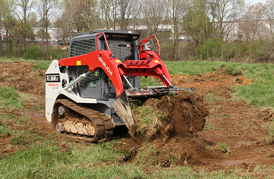 tracked loader working and lifting soil