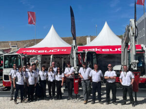 team takeuchi at hillhead stood in front of stand