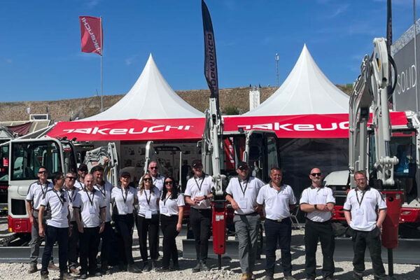 team takeuchi at hillhead stood in front of stand