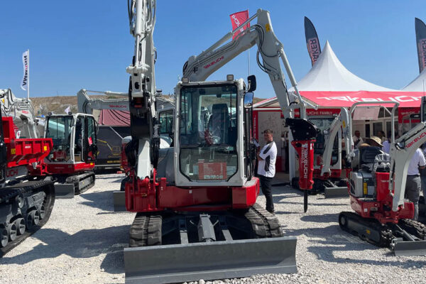 excavator with boom over the top