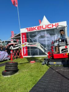 takeuchi operator on digger with tyres