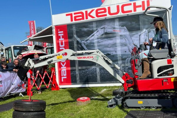 takeuchi operator on digger with tyres