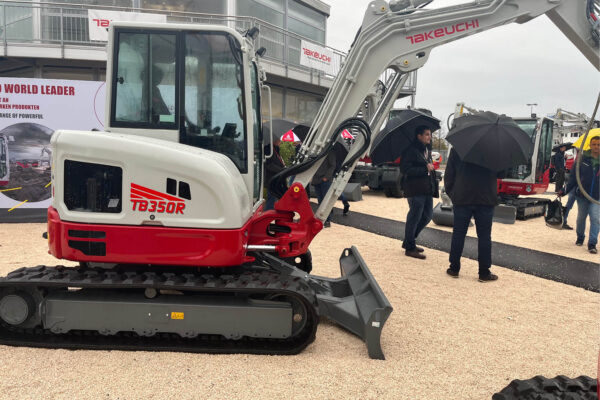 takeuchi digger next to stand