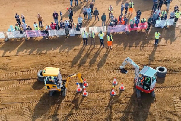 Takeuchi digger vs JCB cone challenge at UKPO event with visitors watching