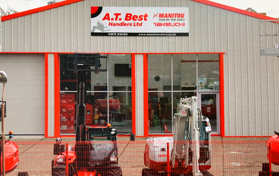 A Takeuchi Digger with another branded excavator in front of A T Best Handlers building