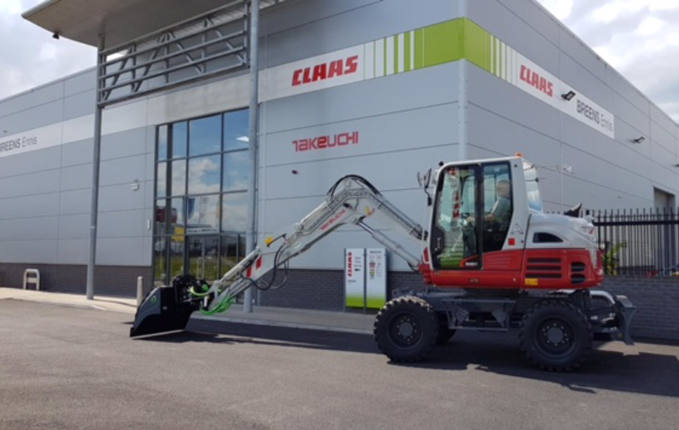 takeuchi tb295w wheeled excavator parked in front of Breens Ennis Depot, Ireland.