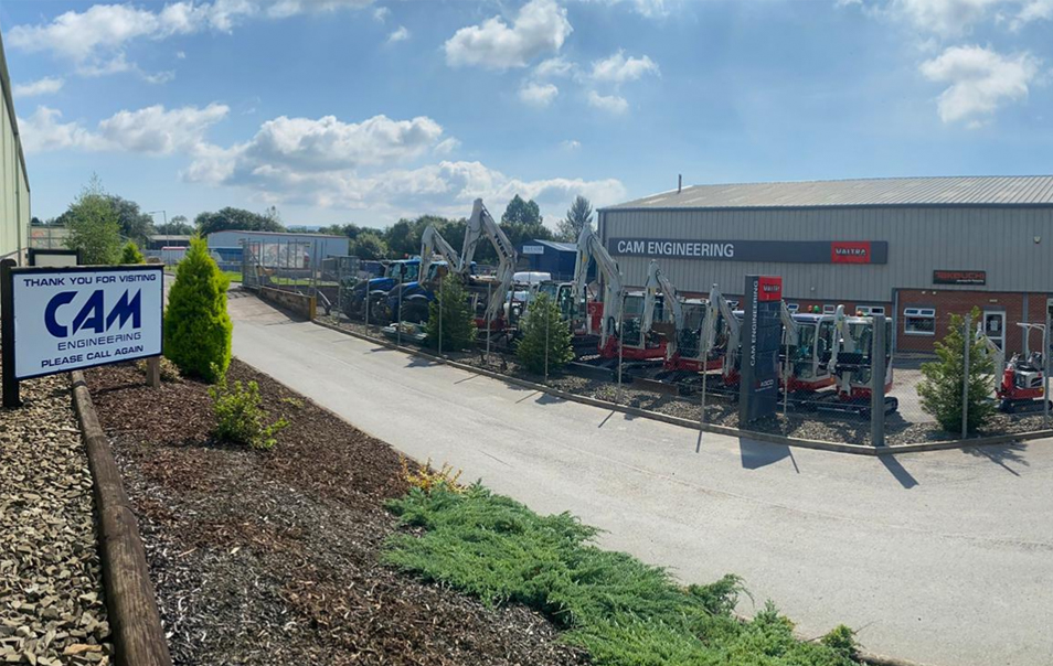 Cam Engineering building with lots of takeuchi diggers parked in front of it