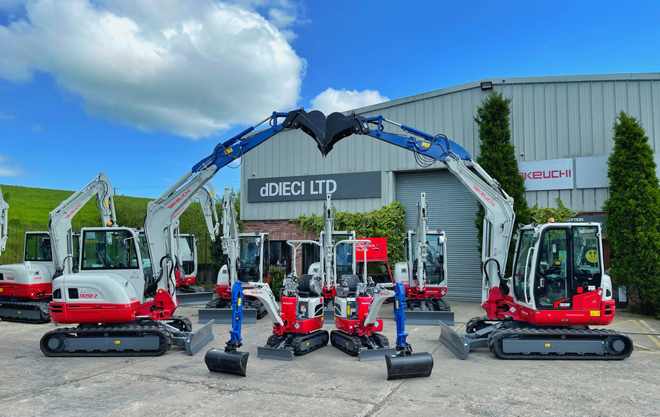 takeuchi excavators in front of dDieci headquarters building. The diggers have got their booms in an arch over some smaller diggers