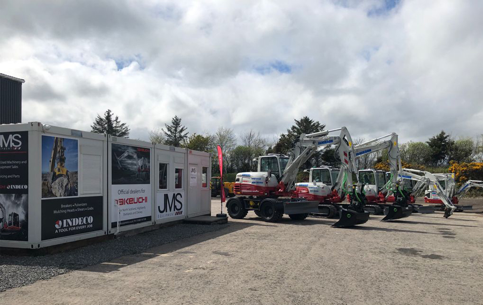 A line up of takeuchi diggers next to JMS Equipment building in scotland