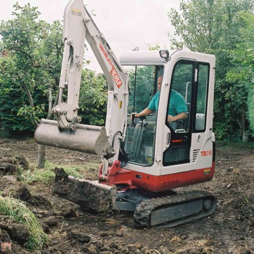 Takeuchi TB016 digger working construction site 2002