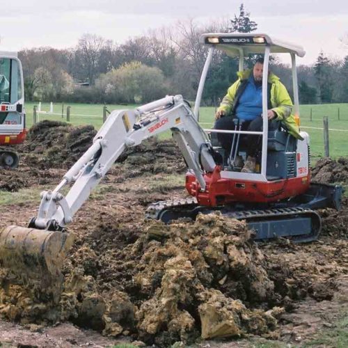 Takeuchi TB016 with operator on a micro digger