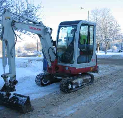 Takeuchi TB125 digger clearing the snow with machinery
