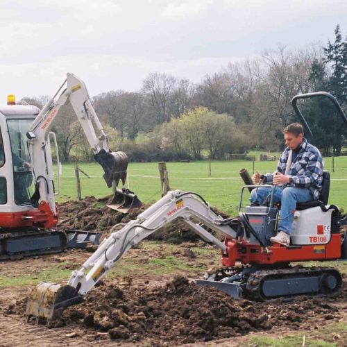 Takeuchi TB108 canopy digger TB014 cabined excavator working together on a site grading and digging