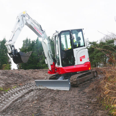 tb335r compact excavator on a hill