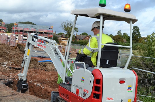 Takeuchi TB216 digger Working construction site with operator driving canopy machinery