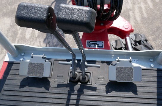 foot pedals and controls of inside the cabin of a takeuchi tb219 micro digger with a spacious footwell