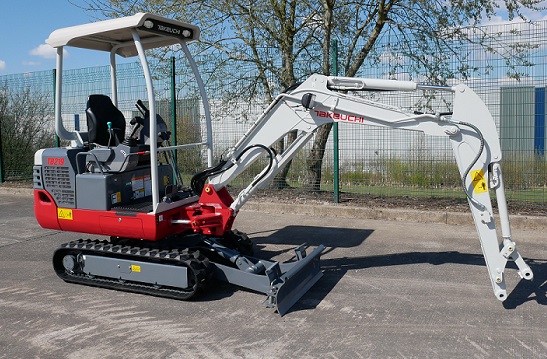 takeuchi tb219 micro digger parked up side angle showing how long the boom is on this machine