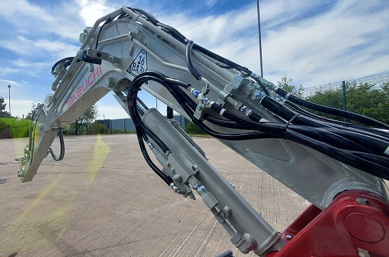 TB230 compact excavator boom arm with piping above the digger arm